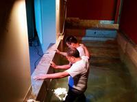 Thomas being baptized